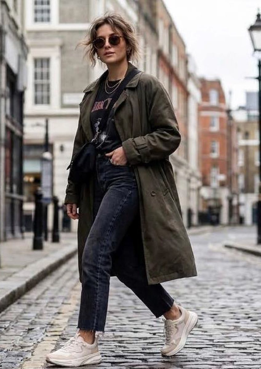A woman in a long coat and HEYDUDE shoes on a cobbled street