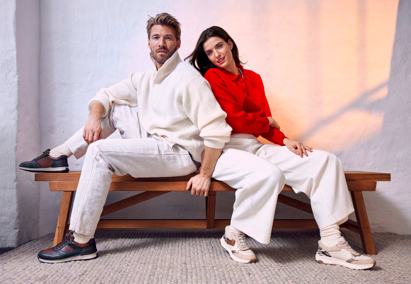A man and a woman in Relife, sitting back to back on a bench