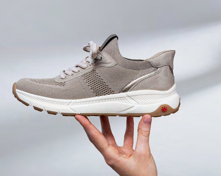A light knitted Relife sneaker held on an open hand